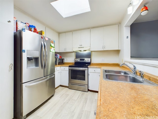 kitchen with white cabinetry, sink, light hardwood / wood-style floors, and appliances with stainless steel finishes