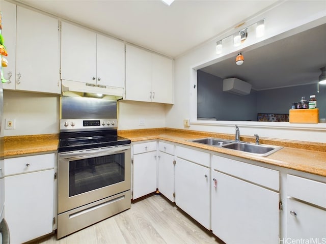 kitchen with white cabinetry, sink, a wall mounted AC, and stainless steel electric range