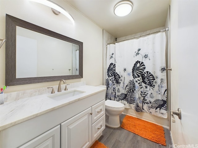 bathroom with hardwood / wood-style flooring, vanity, and toilet