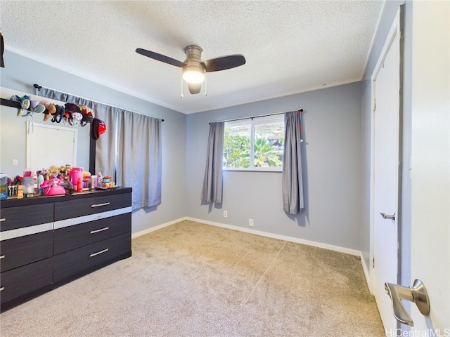 carpeted bedroom featuring ceiling fan and a textured ceiling