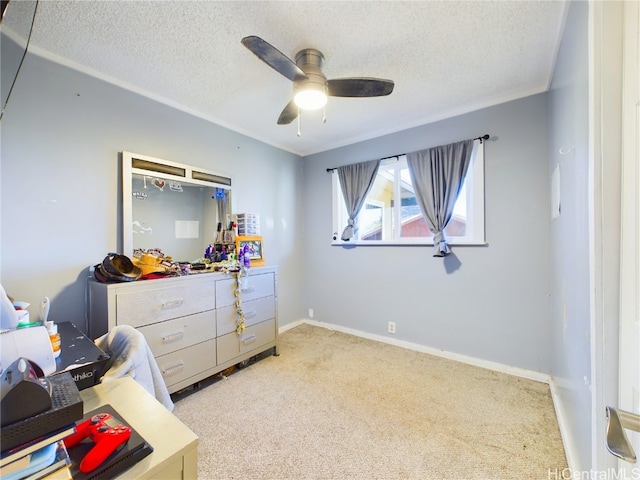 carpeted bedroom featuring ceiling fan and a textured ceiling