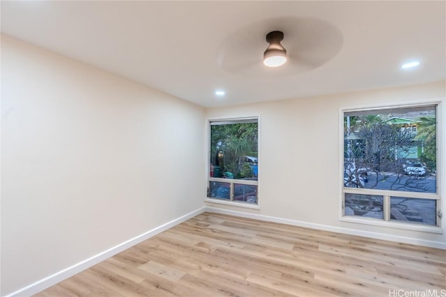 empty room with ceiling fan and light wood-type flooring