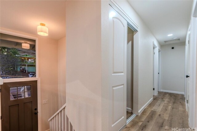 corridor with light wood-type flooring