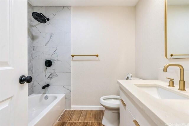 full bathroom featuring vanity, toilet, and tiled shower / bath