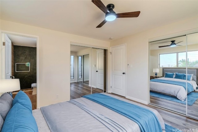 bedroom featuring ceiling fan, dark hardwood / wood-style floors, and multiple windows