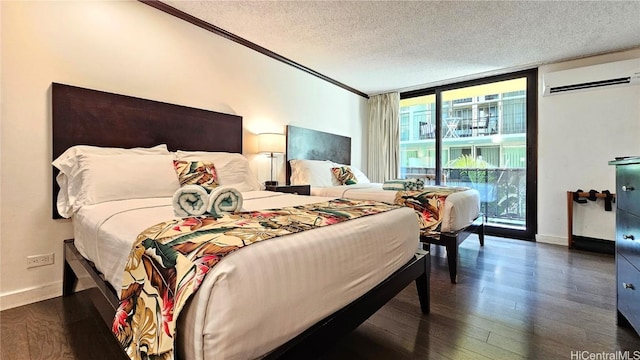 bedroom featuring crown molding, a wall mounted air conditioner, expansive windows, a textured ceiling, and dark hardwood / wood-style flooring