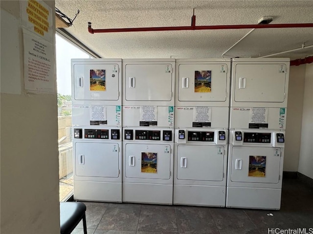 community laundry room with stacked washer / dryer, a textured ceiling, and separate washer and dryer