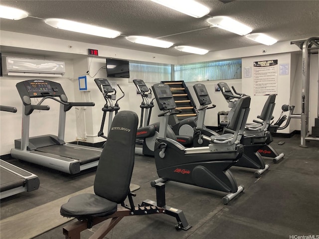 444 Niu St Unit 815, Honolulu, HI 96815 - workout area with a wall mounted air conditioner and a textured ceiling