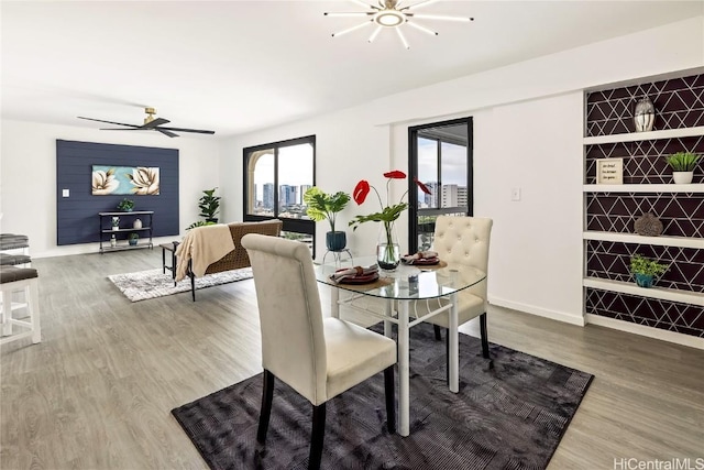 dining area with hardwood / wood-style floors and ceiling fan