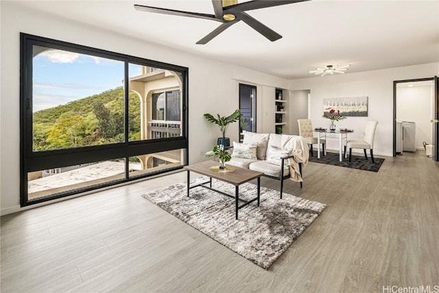 living room featuring wood-type flooring and ceiling fan