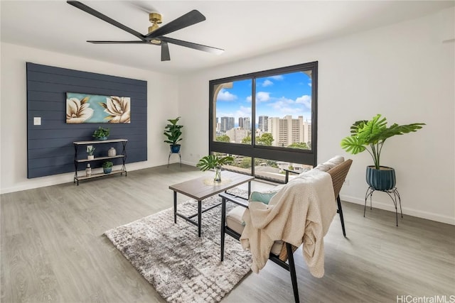 living room with ceiling fan and light hardwood / wood-style floors