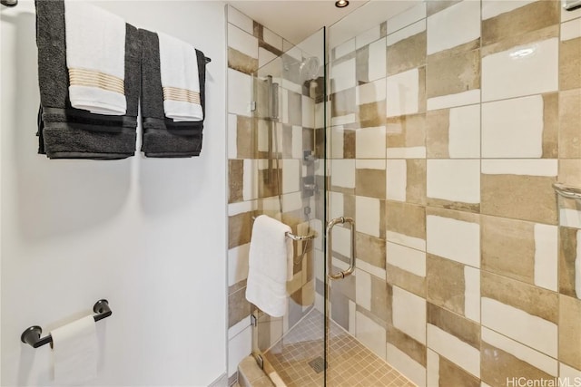 bathroom featuring a shower with door