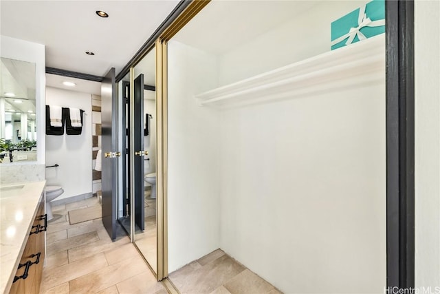 full bathroom with recessed lighting, vanity, and toilet