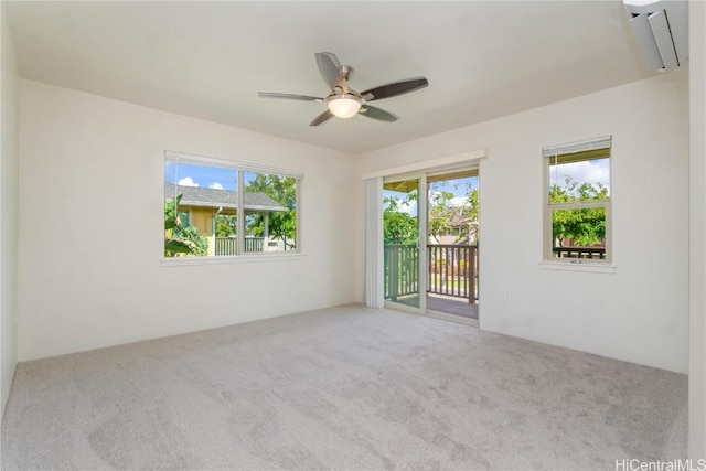 empty room with carpet floors and a ceiling fan