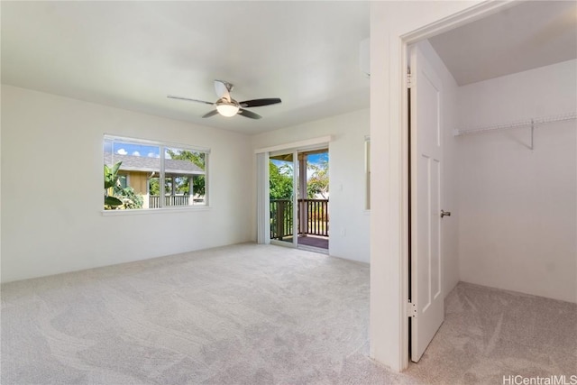 spare room with carpet flooring and a ceiling fan