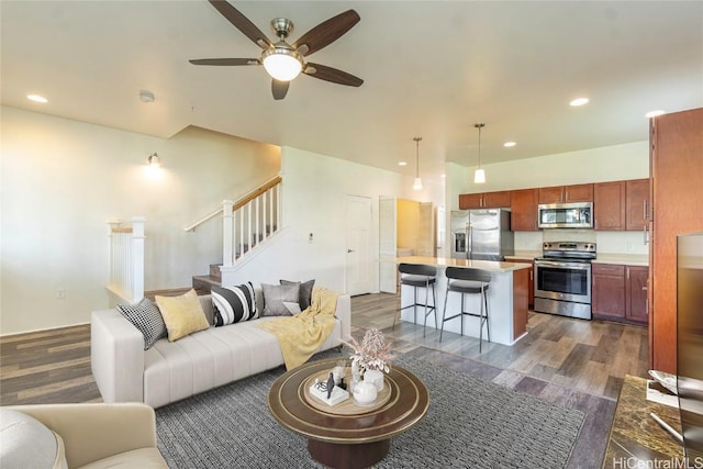 living room featuring ceiling fan, stairway, dark wood-type flooring, and recessed lighting