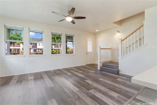 unfurnished living room featuring stairs, wood finished floors, a ceiling fan, and recessed lighting