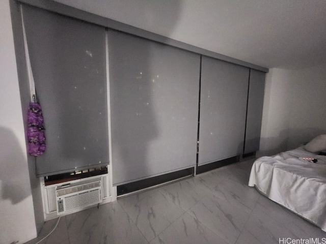 unfurnished bedroom featuring a wall unit AC