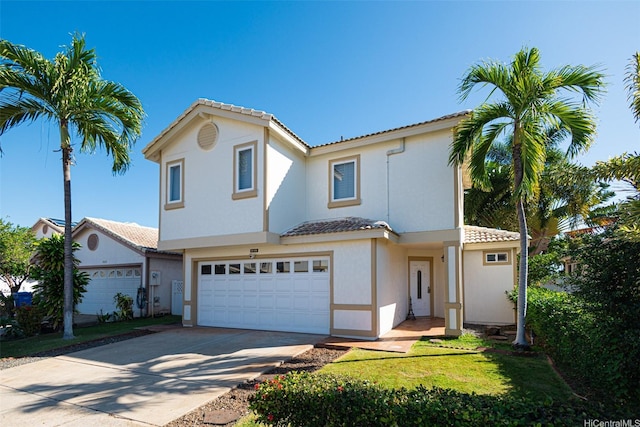 view of front of home with concrete driveway, stucco siding, a tiled roof, and a garage