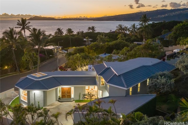 aerial view at dusk with a water view