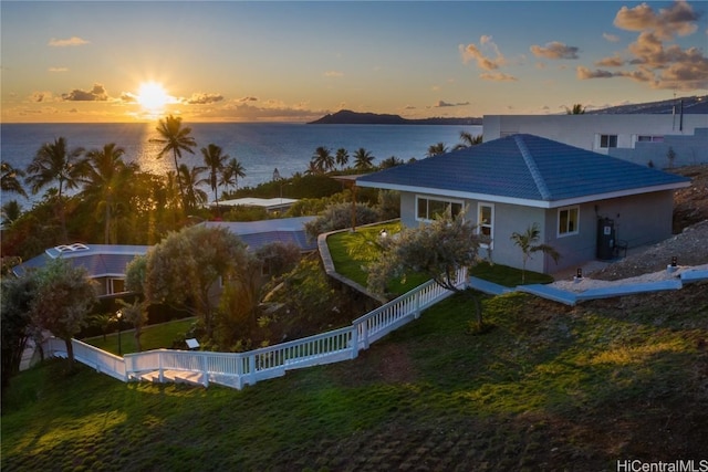 exterior space with a lawn and a water view