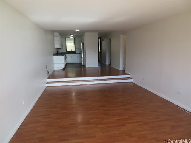 unfurnished living room with dark hardwood / wood-style floors