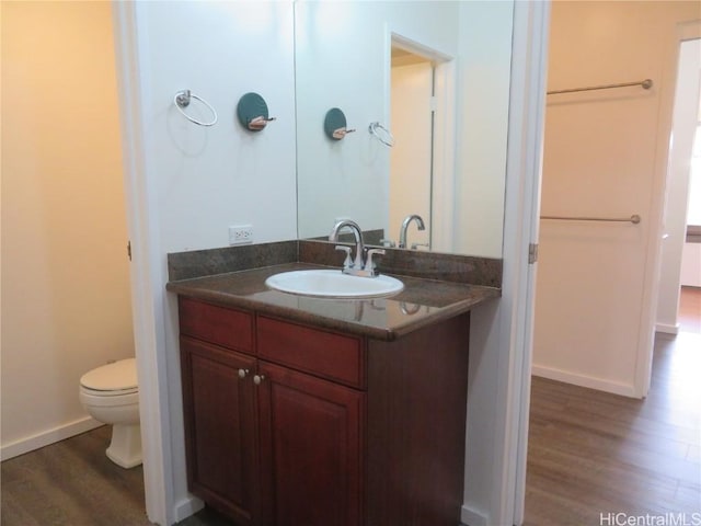 bathroom featuring hardwood / wood-style flooring, vanity, and toilet