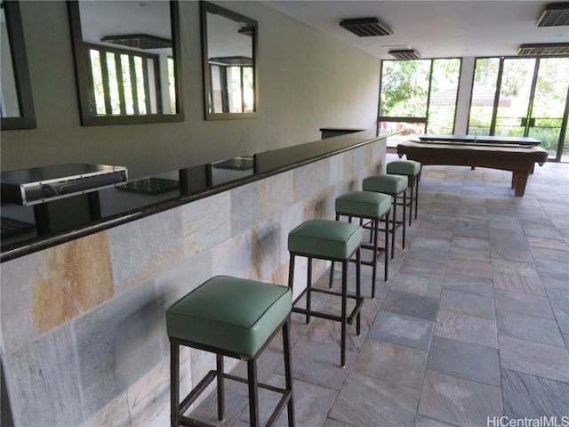 bar featuring a healthy amount of sunlight and billiards