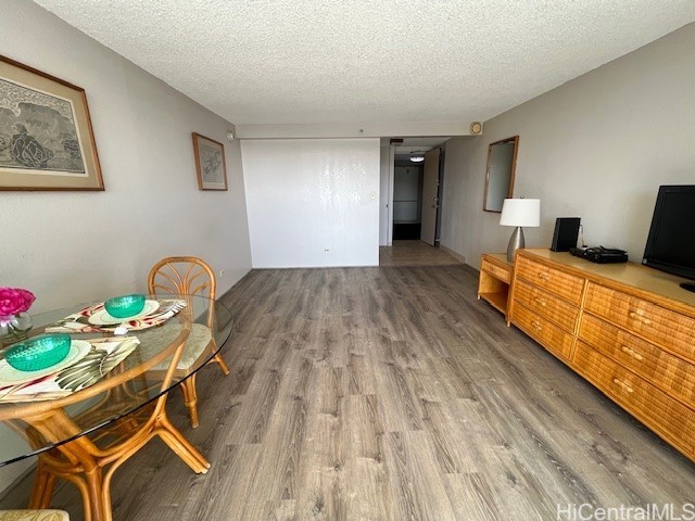 interior space with hardwood / wood-style flooring and a textured ceiling