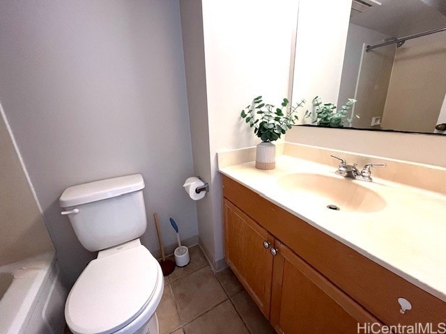 bathroom featuring vanity, tile patterned flooring, a bathing tub, and toilet