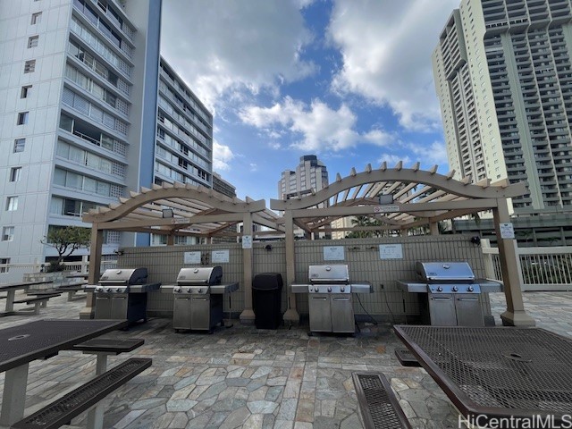 view of patio featuring a grill and a pergola