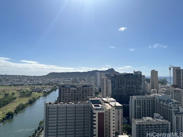 property's view of city with a water and mountain view