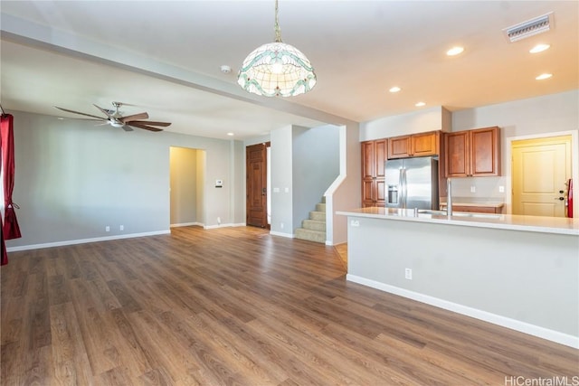 kitchen with dark hardwood / wood-style floors, stainless steel fridge, ceiling fan, and pendant lighting