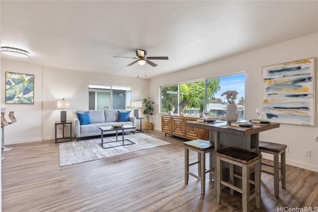 dining room featuring ceiling fan and light hardwood / wood-style floors