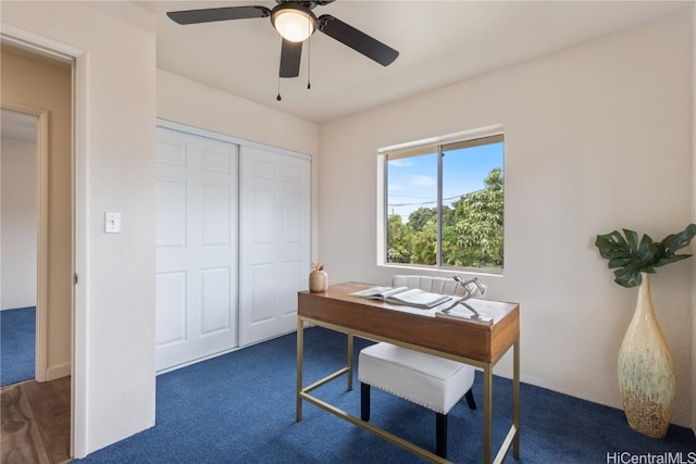 home office featuring ceiling fan and dark carpet