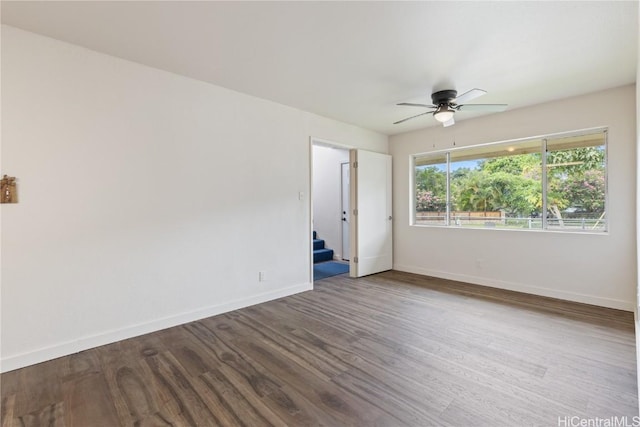 empty room featuring ceiling fan and hardwood / wood-style floors