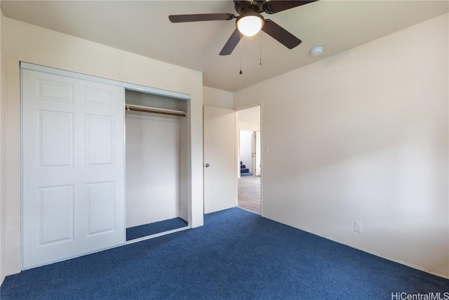 unfurnished bedroom featuring dark carpet, a closet, and ceiling fan