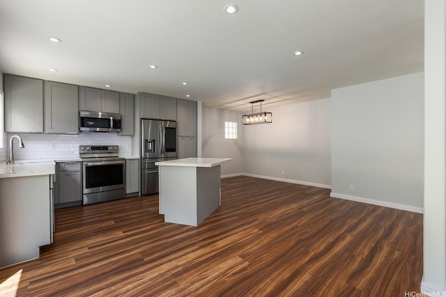 91-1659 Kaukolu St, Ewa Beach, HI 96706 - kitchen featuring appliances with stainless steel finishes, gray cabinetry, a center island, tasteful backsplash, and recessed lighting