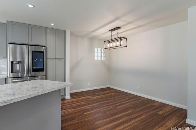 kitchen with gray cabinets, stainless steel refrigerator with ice dispenser, dark wood-type flooring, and decorative light fixtures