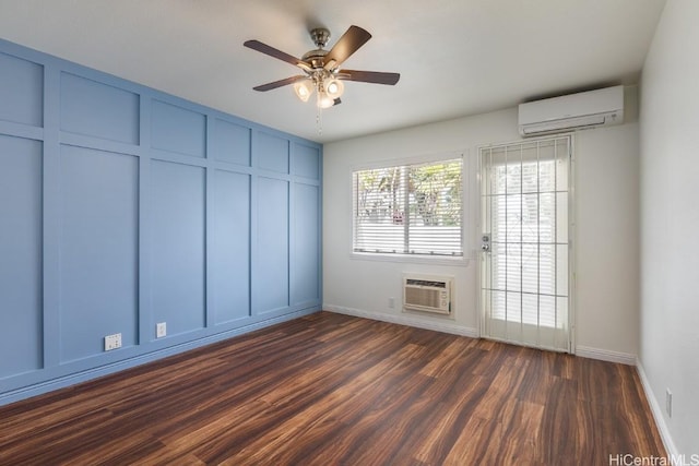 empty room with ceiling fan, dark wood-type flooring, and a wall mounted AC