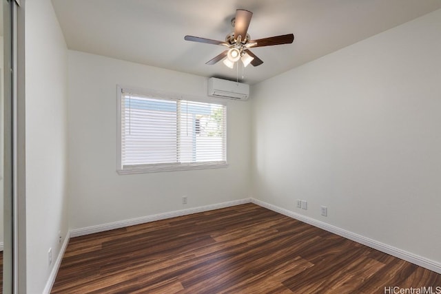 empty room with dark wood-type flooring, ceiling fan, and a wall mounted AC