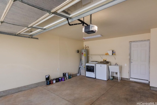 garage featuring a garage door opener, gas water heater, sink, and washing machine and clothes dryer