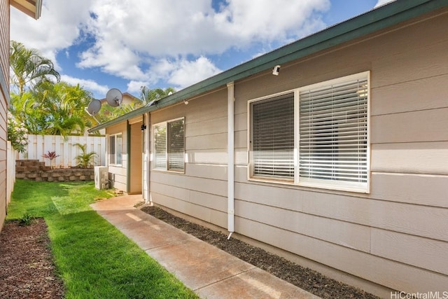 view of side of property with a yard