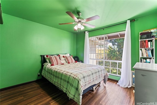 bedroom with dark wood-type flooring and ceiling fan