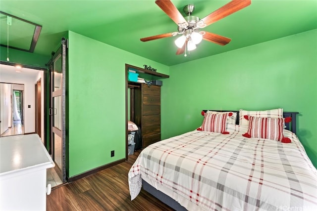 bedroom with ceiling fan and dark hardwood / wood-style floors