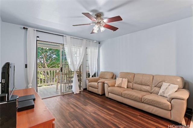 living room with dark wood-type flooring and ceiling fan