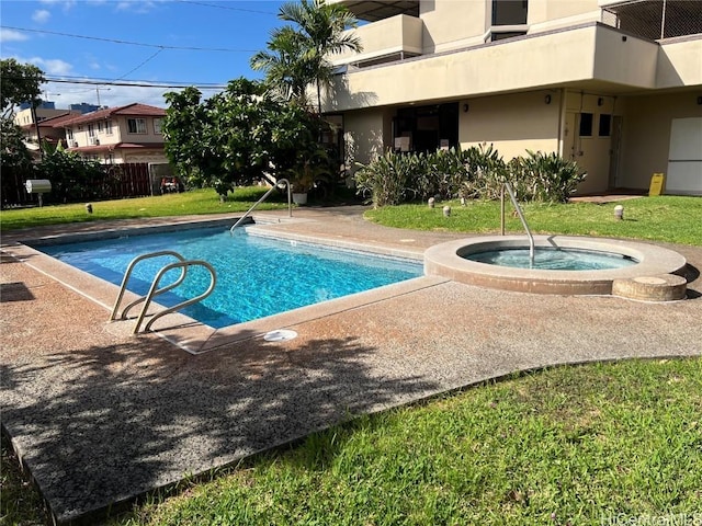 view of swimming pool featuring an in ground hot tub