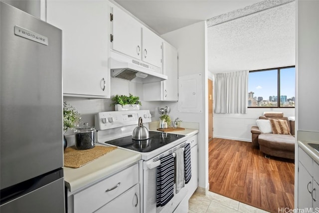 kitchen with light hardwood / wood-style flooring, stainless steel refrigerator, white cabinetry, white range with electric stovetop, and a textured ceiling