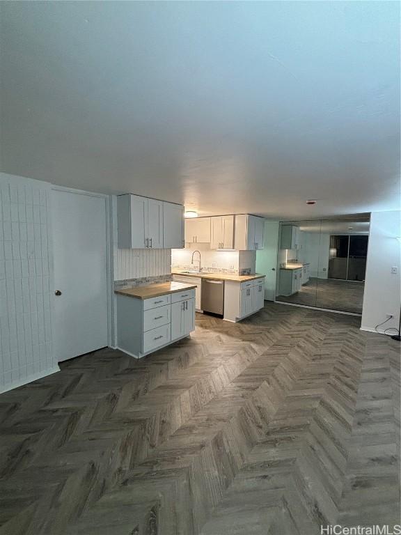 kitchen featuring white cabinetry, sink, and stainless steel dishwasher