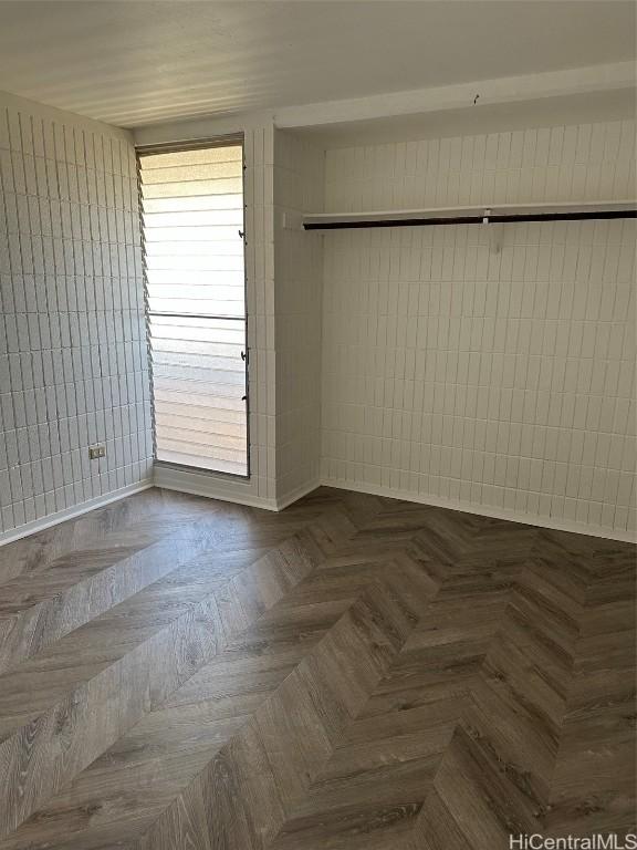 empty room featuring dark parquet floors